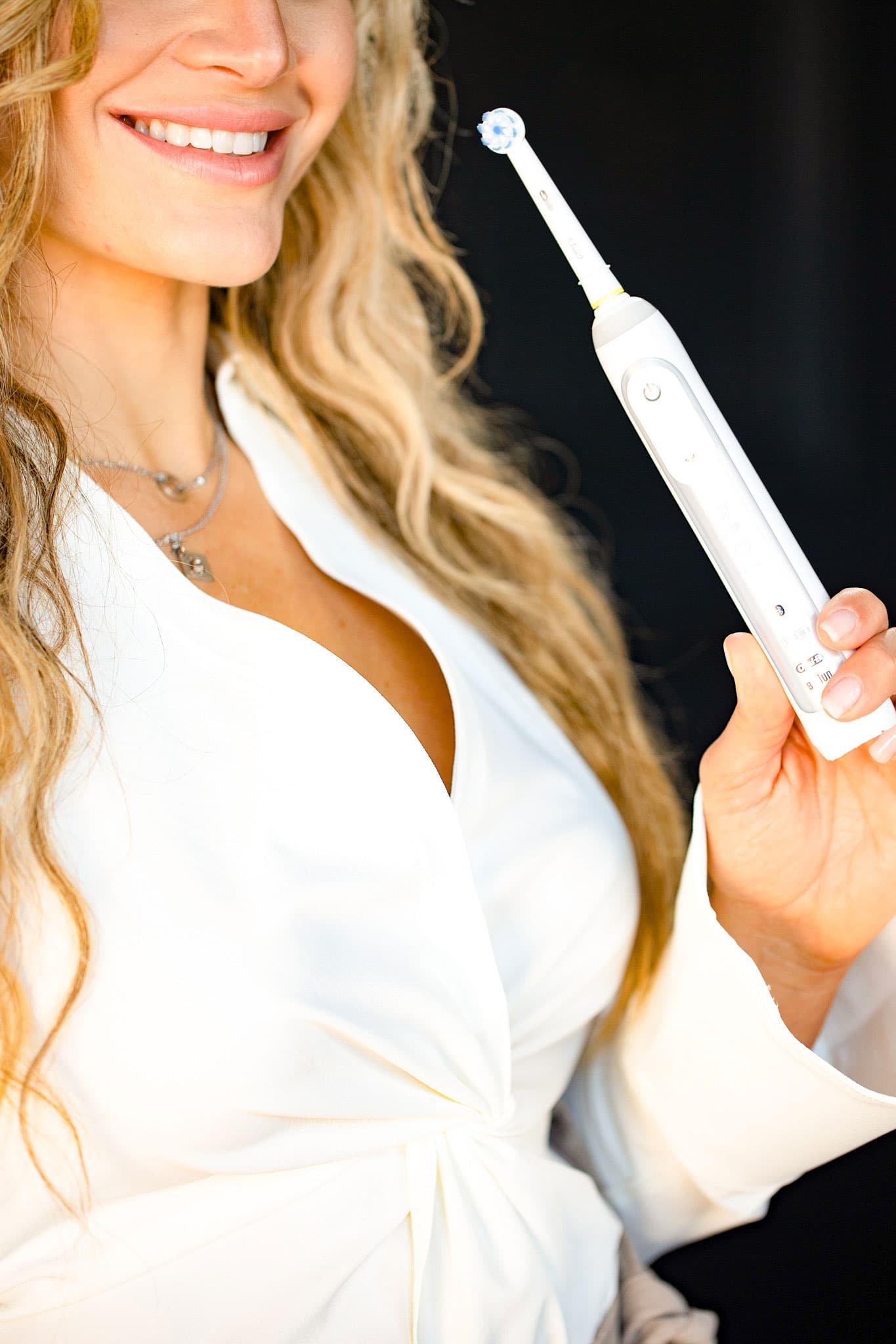 Dr. Jessica Tasios holding electric toothbrush